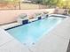 Inviting rectangular pool with stone accents and seating area at 18803 N 16Th Pl, Phoenix, AZ 85024