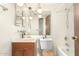 A vintage-styled bathroom with a wood vanity, a large mirror, and unique light fixtures at 1940 S Coconino Dr, Apache Junction, AZ 85120