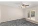 Bright bedroom with sliding glass door to backyard; carpeted floor, ceiling fan at 1940 S Coconino Dr, Apache Junction, AZ 85120