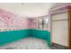 View of an empty bedroom with colorful painted wallpaper, window view and open closet at 1940 S Coconino Dr, Apache Junction, AZ 85120