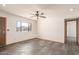 A bright living room features a window, a ceiling fan, and slate flooring at 1940 S Coconino Dr, Apache Junction, AZ 85120