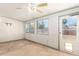 A sunroom featuring multiple windows, a ceiling fan, and access to the backyard at 1940 S Coconino Dr, Apache Junction, AZ 85120