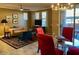 Bright dining area with a glass table and red chairs, leading to a patio at 20100 N 78Th Pl # 1092, Scottsdale, AZ 85255