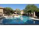 Inviting community pool with surrounding lounge chairs and landscaping at 20100 N 78Th Pl # 1092, Scottsdale, AZ 85255