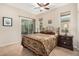 Bedroom with a queen bed, dark wood furniture, and access to a patio at 20652 N Wishing Well Ln, Maricopa, AZ 85138