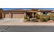 Single-story home with three-car garage and landscaped front yard at 20652 N Wishing Well Ln, Maricopa, AZ 85138