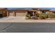 Single-story house with three-car garage and desert landscaping at 20652 N Wishing Well Ln, Maricopa, AZ 85138