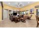 Spacious living room with comfortable seating, a large TV, and a stone fireplace at 20652 N Wishing Well Ln, Maricopa, AZ 85138