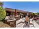 Outdoor kitchen and patio area with seating and a grill at 20652 N Wishing Well Ln, Maricopa, AZ 85138