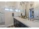 Bathroom with marble shower, double vanity, and modern fixtures at 23219 N 41St St, Phoenix, AZ 85050