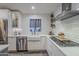 Kitchen with white cabinets, farmhouse sink, and stainless steel appliances at 23219 N 41St St, Phoenix, AZ 85050