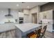 Modern kitchen with white cabinets, island, and stainless steel appliances at 23219 N 41St St, Phoenix, AZ 85050