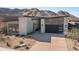 Modern home exterior with stone accents and mountain backdrop at 23766 N 123Rd Way, Scottsdale, AZ 85255