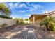 Landscaped backyard, patio, and stone pathway at 25636 S Howard Dr, Sun Lakes, AZ 85248