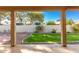 Landscaped backyard with grassy area and patio at 25636 S Howard Dr, Sun Lakes, AZ 85248