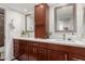 Double vanity bathroom with dark wood cabinets and a walk-in shower at 25636 S Howard Dr, Sun Lakes, AZ 85248