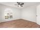 Bright bedroom featuring wood-look floors and ceiling fan at 25636 S Howard Dr, Sun Lakes, AZ 85248