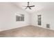 Simple bedroom with tile floors, ceiling fan and door to exterior at 25636 S Howard Dr, Sun Lakes, AZ 85248