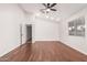 Bright bedroom featuring wood-look floors and a ceiling fan at 25636 S Howard Dr, Sun Lakes, AZ 85248