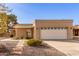 Tan stucco home with a two-car garage and walkway at 25636 S Howard Dr, Sun Lakes, AZ 85248