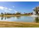 Scenic golf course with pond and clubhouse in background at 25636 S Howard Dr, Sun Lakes, AZ 85248