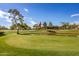 Green golf course with pond and clubhouse at 25636 S Howard Dr, Sun Lakes, AZ 85248