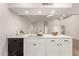 Stylish kitchen featuring white cabinets, quartz countertops, and a double sink at 25636 S Howard Dr, Sun Lakes, AZ 85248