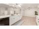 Contemporary kitchen with white cabinets, island, and black dishwasher at 25636 S Howard Dr, Sun Lakes, AZ 85248