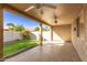 Covered patio with ceiling fans, grassy backyard, and stone pathway at 25636 S Howard Dr, Sun Lakes, AZ 85248