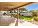 Extended covered patio, grassy backyard, and decorative landscaping at 25636 S Howard Dr, Sun Lakes, AZ 85248