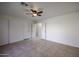 Spacious bedroom with tile floors, ceiling fan, and ample closet space at 2828 E Blackhawk Dr, Phoenix, AZ 85050