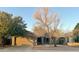 Tan one-story house with attached garage and mature landscaping at 2828 E Blackhawk Dr, Phoenix, AZ 85050