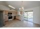 Kitchen with light wood cabinets, stainless steel appliances, and access to the backyard at 2828 E Blackhawk Dr, Phoenix, AZ 85050