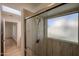 Walk-in shower with glass doors and a window for natural light at 2828 E Blackhawk Dr, Phoenix, AZ 85050