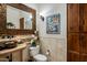 Elegant bathroom featuring a decorative mirror, tiled wall, artwork, and cabinet at 30014 N Baker Ct, Scottsdale, AZ 85262