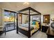 Bedroom with comfortable four-poster bed and sliding door to patio at 30014 N Baker Ct, Scottsdale, AZ 85262