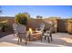 Stone fire pit with four chairs in a desert landscape at 30014 N Baker Ct, Scottsdale, AZ 85262