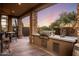 Outdoor kitchen with built-in grill and bar seating at 30014 N Baker Ct, Scottsdale, AZ 85262