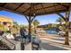 Covered patio with seating area overlooking the pool and spa at 30014 N Baker Ct, Scottsdale, AZ 85262