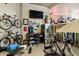 Basement recreation room with exercise equipment, bikes, and a desk at 30014 N Baker Ct, Scottsdale, AZ 85262