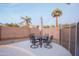 Small patio table with chairs, umbrella, and view of a block wall at 306 E Dennisport Ct, Gilbert, AZ 85295