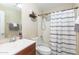 Clean bathroom with shower/tub combo and wood vanity at 306 E Dennisport Ct, Gilbert, AZ 85295