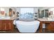 Spa-like bathroom with a freestanding tub and double sinks at 306 E Dennisport Ct, Gilbert, AZ 85295