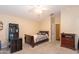 Charming bedroom with wood furniture and ceiling fan at 306 E Dennisport Ct, Gilbert, AZ 85295