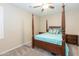 Bedroom with a wooden post bed and ceiling fan at 306 E Dennisport Ct, Gilbert, AZ 85295