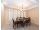 Formal dining room with a large table and chairs, chandelier, and tile floors at 306 E Dennisport Ct, Gilbert, AZ 85295