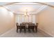 Formal dining room featuring a large table, chandelier, and tile floors at 306 E Dennisport Ct, Gilbert, AZ 85295