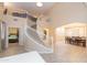 Elegant two-story entryway with curved staircase and views of the formal dining room and bedroom at 306 E Dennisport Ct, Gilbert, AZ 85295