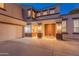 Two-story house with a three-car garage and lighted entryway at 306 E Dennisport Ct, Gilbert, AZ 85295