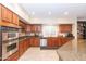 Well-equipped kitchen featuring double ovens and granite countertops at 306 E Dennisport Ct, Gilbert, AZ 85295